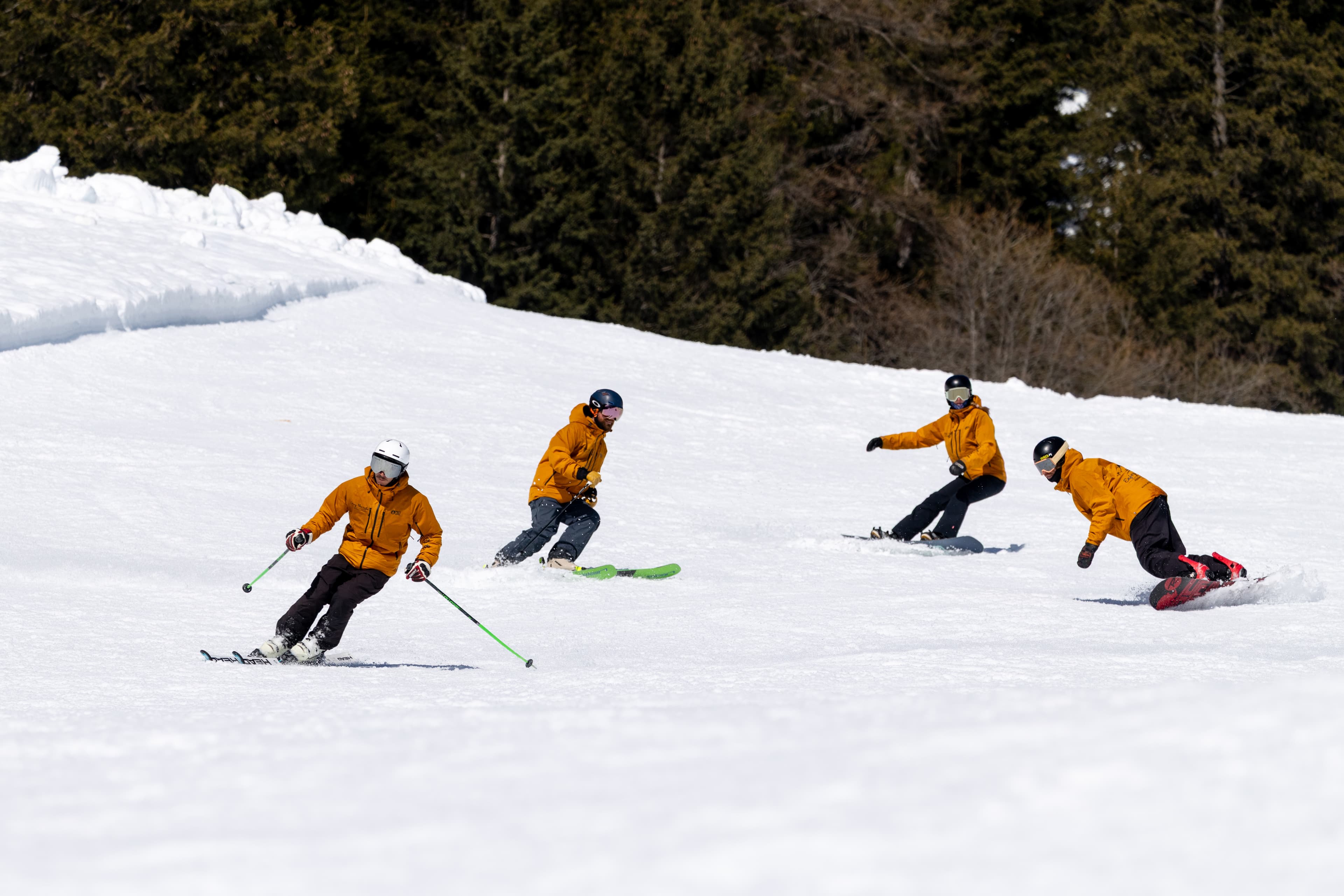 Ski and snowboard instructors from Enjoy the ride riding Crans-Montana slopes