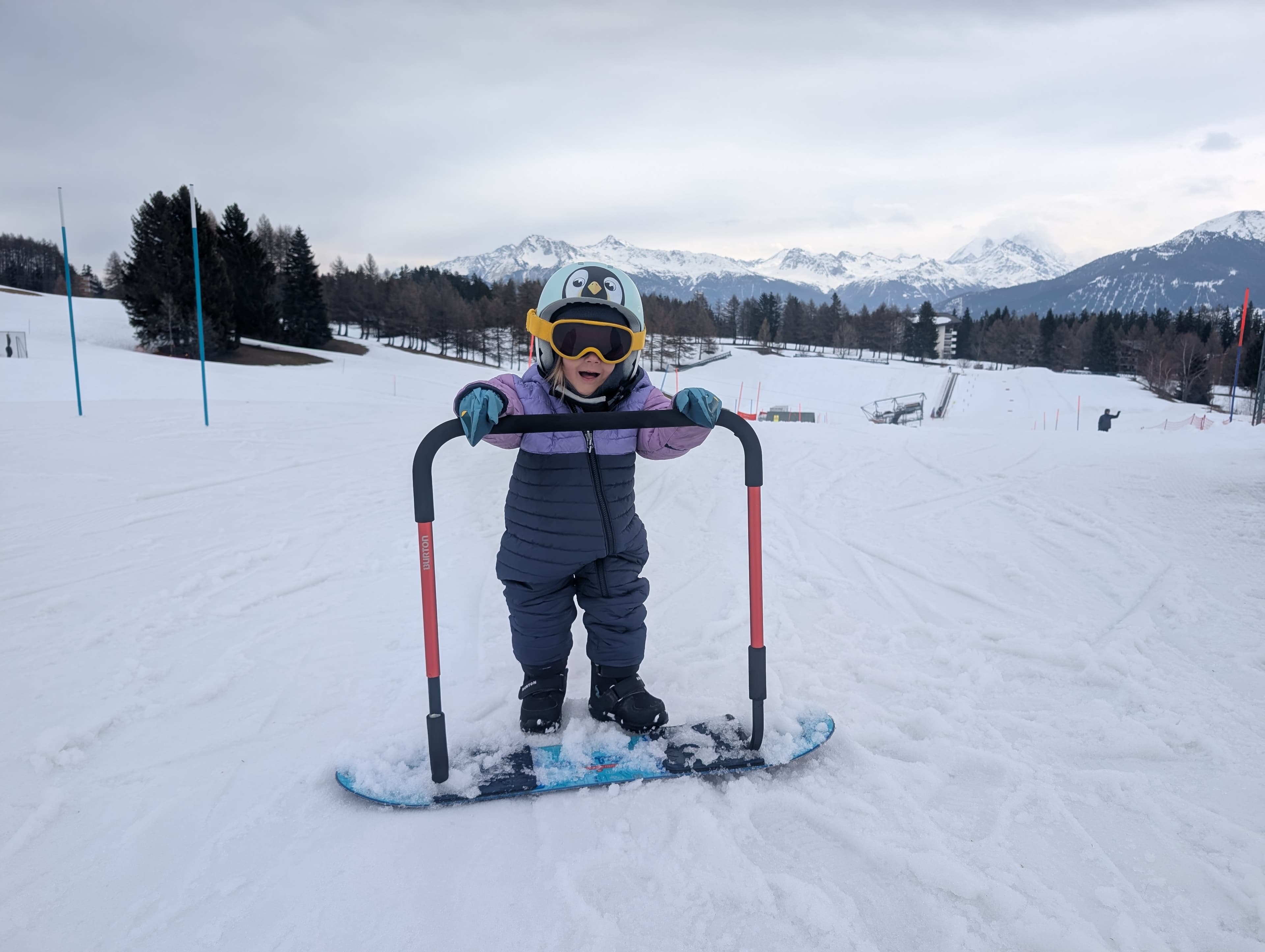 Toddler snowboarding in Crans-Montana